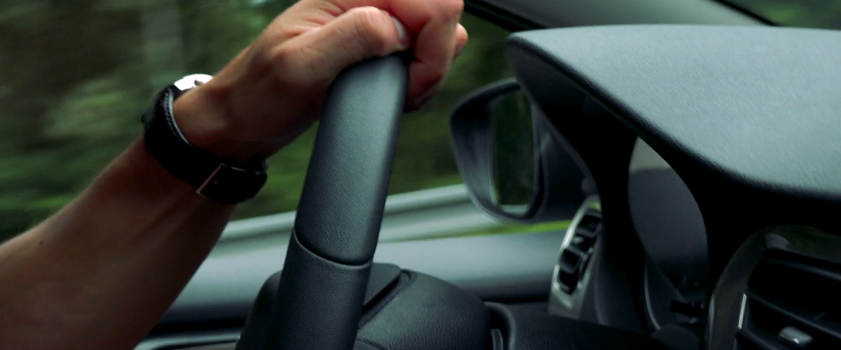 Man drives a car 1200x500